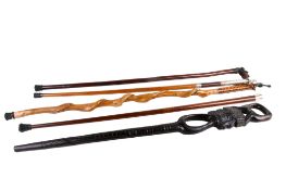 Five assorted walking canes.