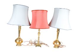 Three large brass table lamps.