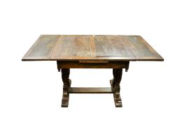 A 20th century oak draw leaf dining table. Having baluster supports united by a stretcher.