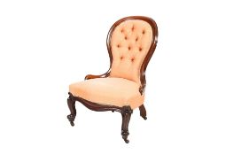 A Victorian mahogany peach upholstered button back nursing chair.