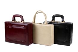 Three women's vintage leather dressing cases.