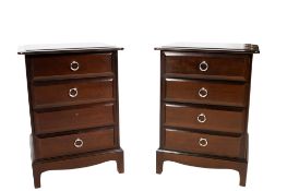 A pair of stained wood Stag bedside cabinets.