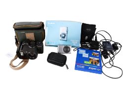 Two compact digital cameras and a film camera and accessories.
