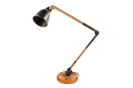 A vintage industrial adjustable workshop lamp. Raised on a heavy circular metal base, Max H105cm.