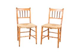 A pair of rush seat dining chairs. Faux bamboo front supports with double stretchers to the side.