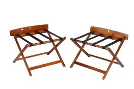 A pair of wooden framed folding suitcase rack or stand.