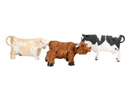 Three ceramic models of cows. Including an Art Studio Pottery Friesian example, H20cm.