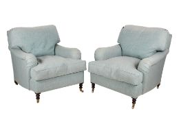 A pair of contemporary armchairs in the style of Howard & Sons.