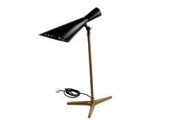 A contemporary adjustable table lamp. Having a black painted perforated shade and brass stand.