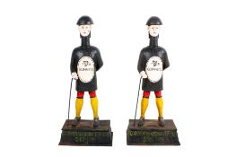 A pair of reproduction Guinness 'bottle man' cast metal money boxes.
