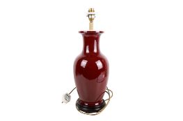 A contemporary Chinese sang de boeuf vase table lamp. Raised on a turned wooden base.