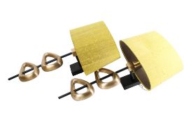 A pair of contemporary brass wall light sconces. Having asymmetric cast brass decoration.