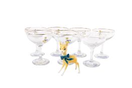 A set of seven mid-century Babycham glasses and a fawn figurine.
