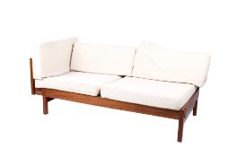 A mid-century sofa day bed. Having sliding storage beneath the seat, raised on square supports.