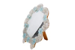 A mid-century Murano glass vanity table mirror. Having opalescent glass and blue rosettes.