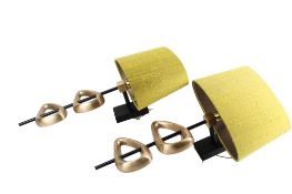 A pair of contemporary brass wall light sconces. Having asymmetric cast brass decoration.