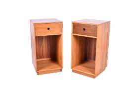 A pair of circa 2012 John M. Haynes pine bedside cabinets.