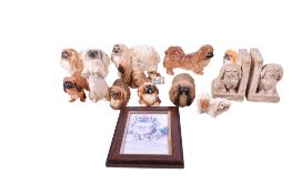 A collection of ceramic Pekinese dog figures. Including a pair of bookends signed 'E.