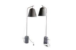 A pair of mid-century arc floor lamps with grey metal bell shades.