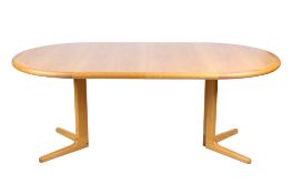 A mid-century extending circular Danish oak table with label Laurite M Sarcens.