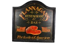 A painted wood 'Flannagans' reproduction sign. Featuring Stars and Strips flags and a T-bone steak.