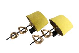 A pair of contemporary brass wall light sconces. Having asymmetric cast brass decoration.