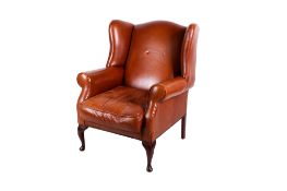 A Laura Ashley brown leather wing back armchair.