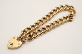 A 9ct gold link bracelet. With hallmarked heart locket, end link marked 9c, L19.