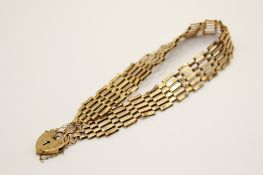 A yellow metal gate link bracelet.