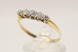 An 18ct gold (tested) five stone diamond ring. Set with old brilliant cut diamonds of 0.