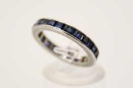 A sapphire eternity ring. With twenty channel square cut sapphires, circa 1.
