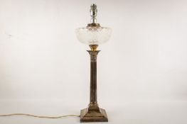 An early 20th century weighted silver converted oil lamp.