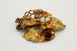 A yellow metal and stone set brooch.