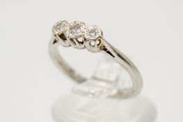A platinum three stone diamond ring.