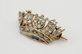 A yellow metal and diamond brooch in the form of a diadem.