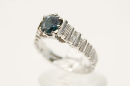An 18ct white gold and sapphire ring. The slightly oval cut sapphire circa 0.