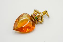 A yellow metal and citrine coronet pendant. The faceted heart shaped stone circa 2.1cm x 1.
