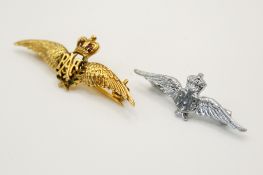 A 9ct gold RAF 'sweetheart' pin badge and a white metal example.