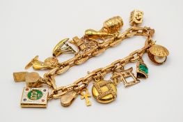 An Italian 18ct gold charm bracelet with assorted gold and yellow metal charms.