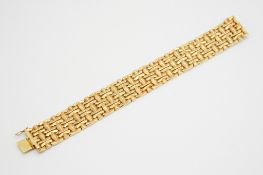 An 18ct gold link bracelet. With textured details of variegated height, hallmarked, W2.1cm x L18.