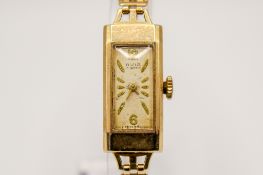 A 9ct gold lady's Avia wristwatch. Gilt markers to the rectangular face, case measuring 2.