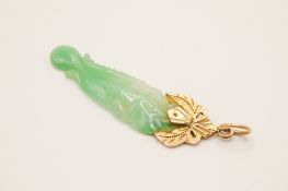 A pale apple green jadeite fish pendant.