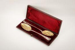 A pair of George III silver berry spoons.