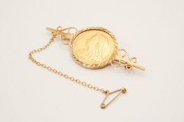 An 1896 gold sovereign coin mounted as a brooch in 9ct gold.