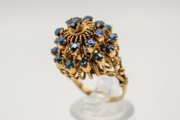 An Indian style yellow metal and sapphire dress ring.
