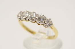 An 18ct diamond five stone ring. Slightly graduated sized stones, largest circa 0.