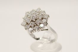 An 18ct white gold (tested) cluster ring. Set with round brilliant cut diamonds of 2.