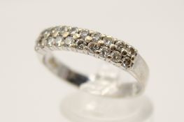 An 18ct white gold (tested) and diamond dress ring. Set with round brilliant cut diamonds of 0.