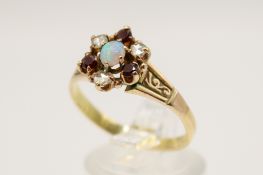 An 18ct gold (tested) dress ring. Set centrally with one oval cabochon cut opal of 0.