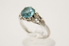 An 18ct gold and blue zircon ring. The round faceted stone 7.